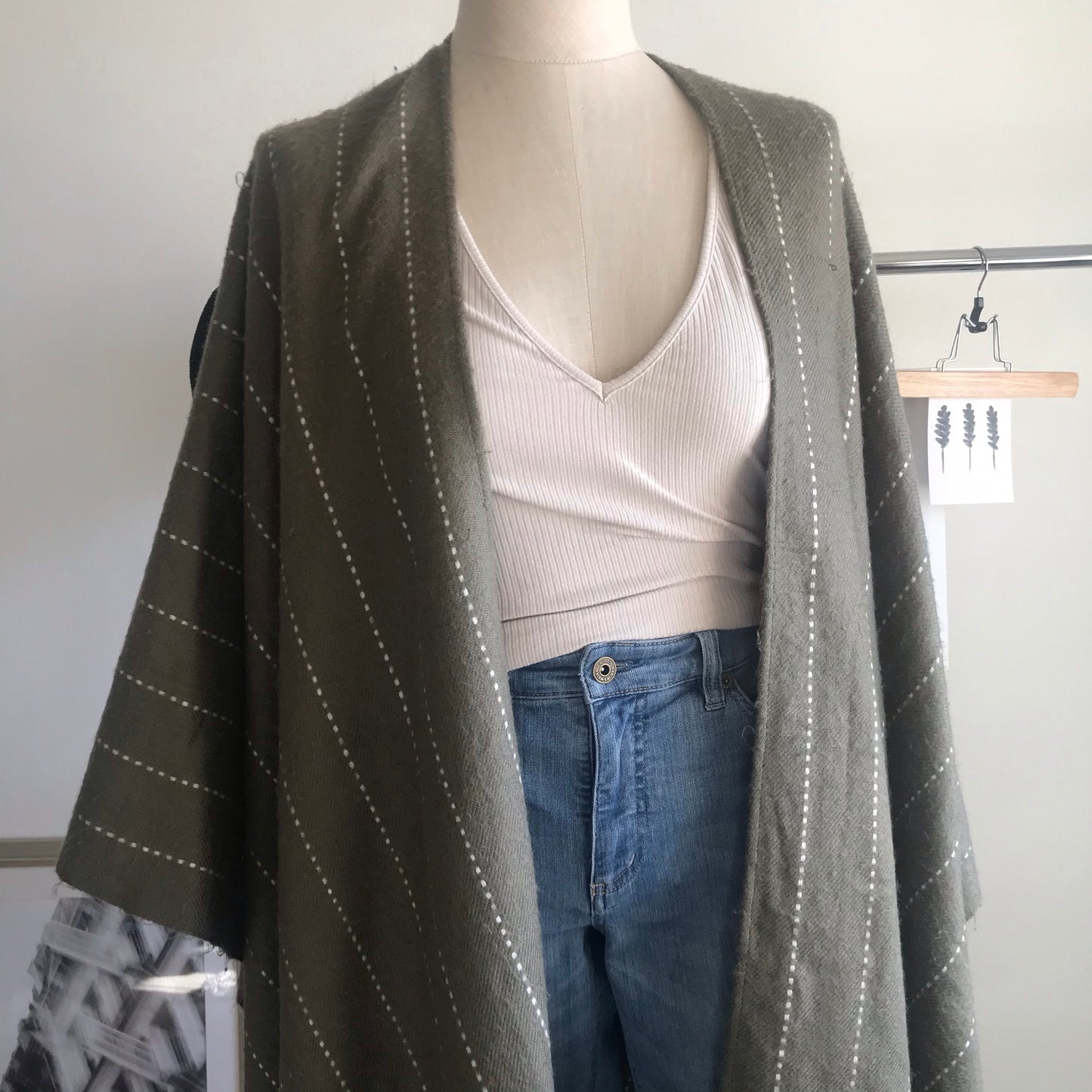 Olive green and white striped poncho. One size.