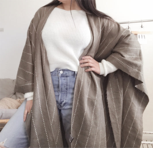 Olive green and white striped poncho. One size.